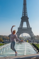Girl jumping in front of Eiffel Tower, Paris